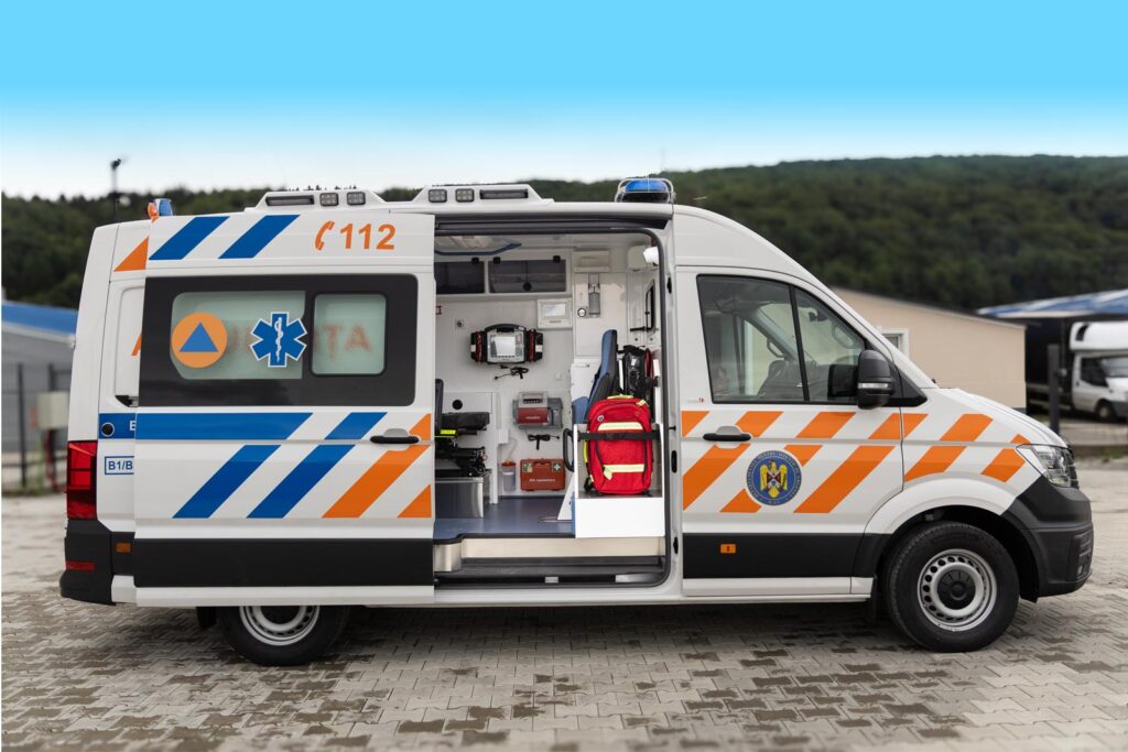 White Volkswagen Crafter Type B emergency road ambulance, modified, featuring an open sliding door showcasing the medical cabin layout.